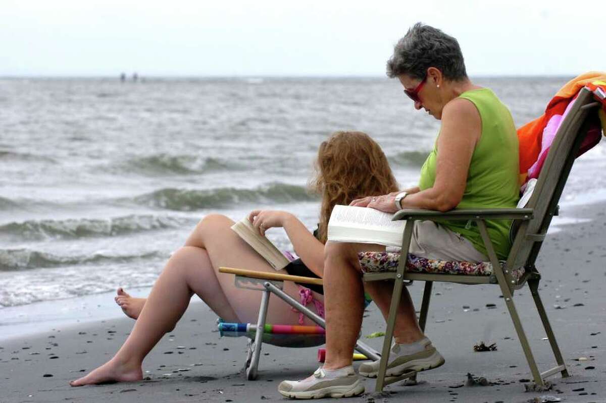Joan Perugine and her granddaughter Katherine Drewry read on the beach near Silver Sands State park in Milford, Conn. Aug. 25th, 2011.