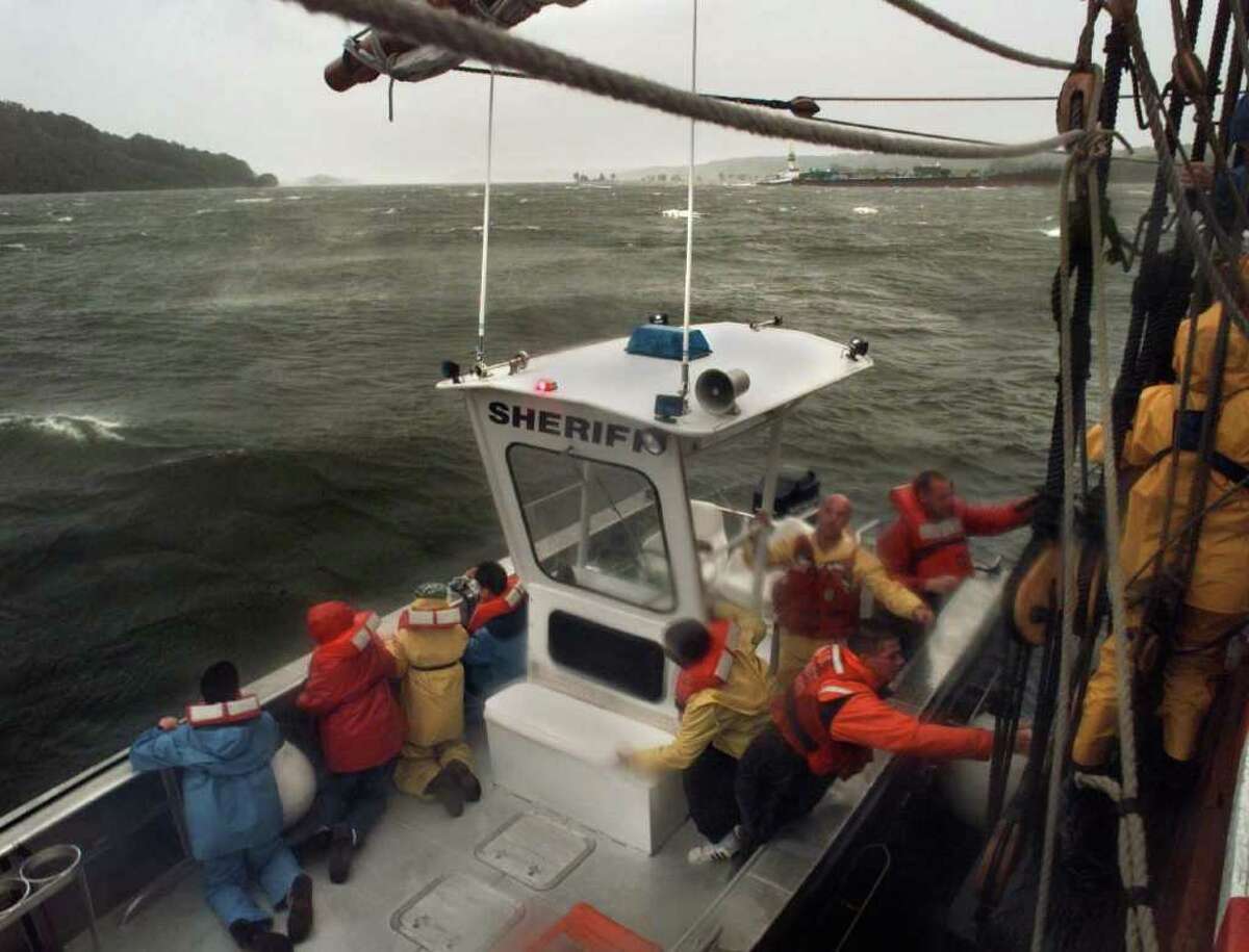 Coast Guard personnel aboard a Ulster County Sheriff's evacuate school children from the Half Moon on the Hudson River near Saugerties on Sept. 16, 1999, as the brunt of Hurricane Floyd passed through the region. The 12 school students and three teachers were off loaded as a precautionary measure. (Paul Buckowski/Times Union archive)