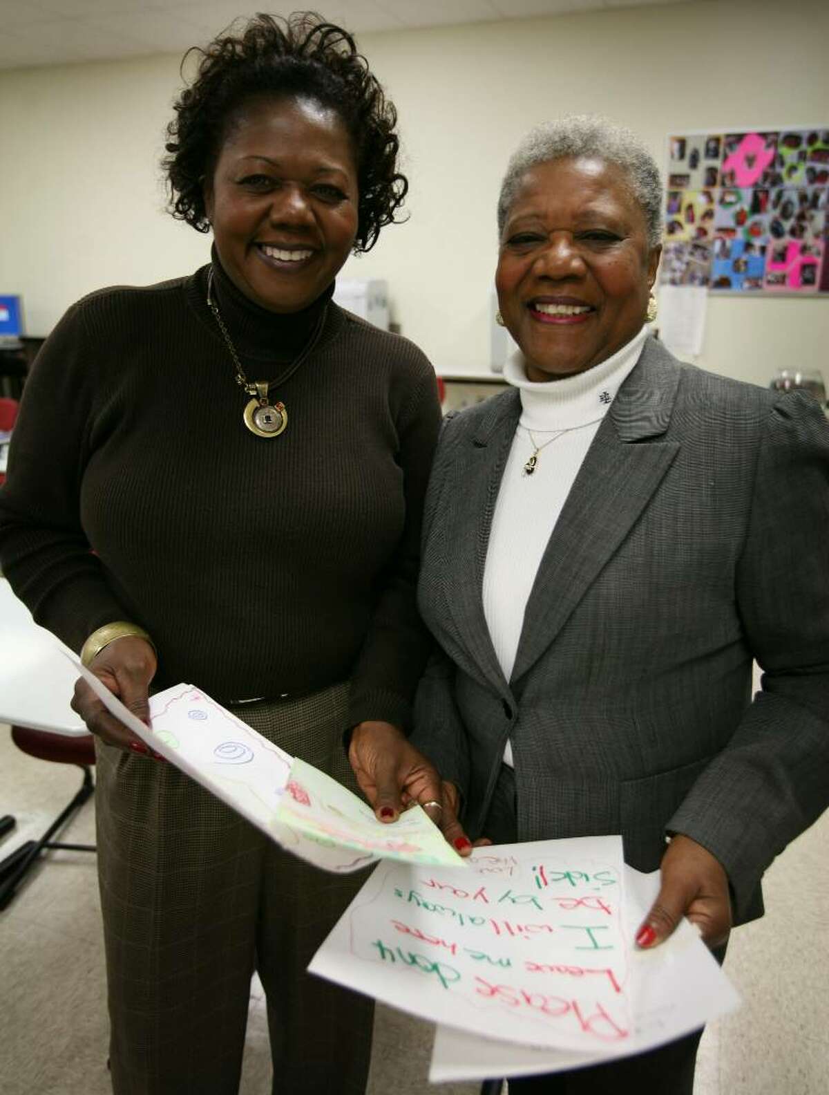 Assistant Supt. of Schools Denise Clemons, left and her mother Barbara Clemons recently participated in a door-to-door "No Excuses" campaign to get students to return to school. Barbara Clemons used artwork and writings that she had saved from one former student to convince him to return.