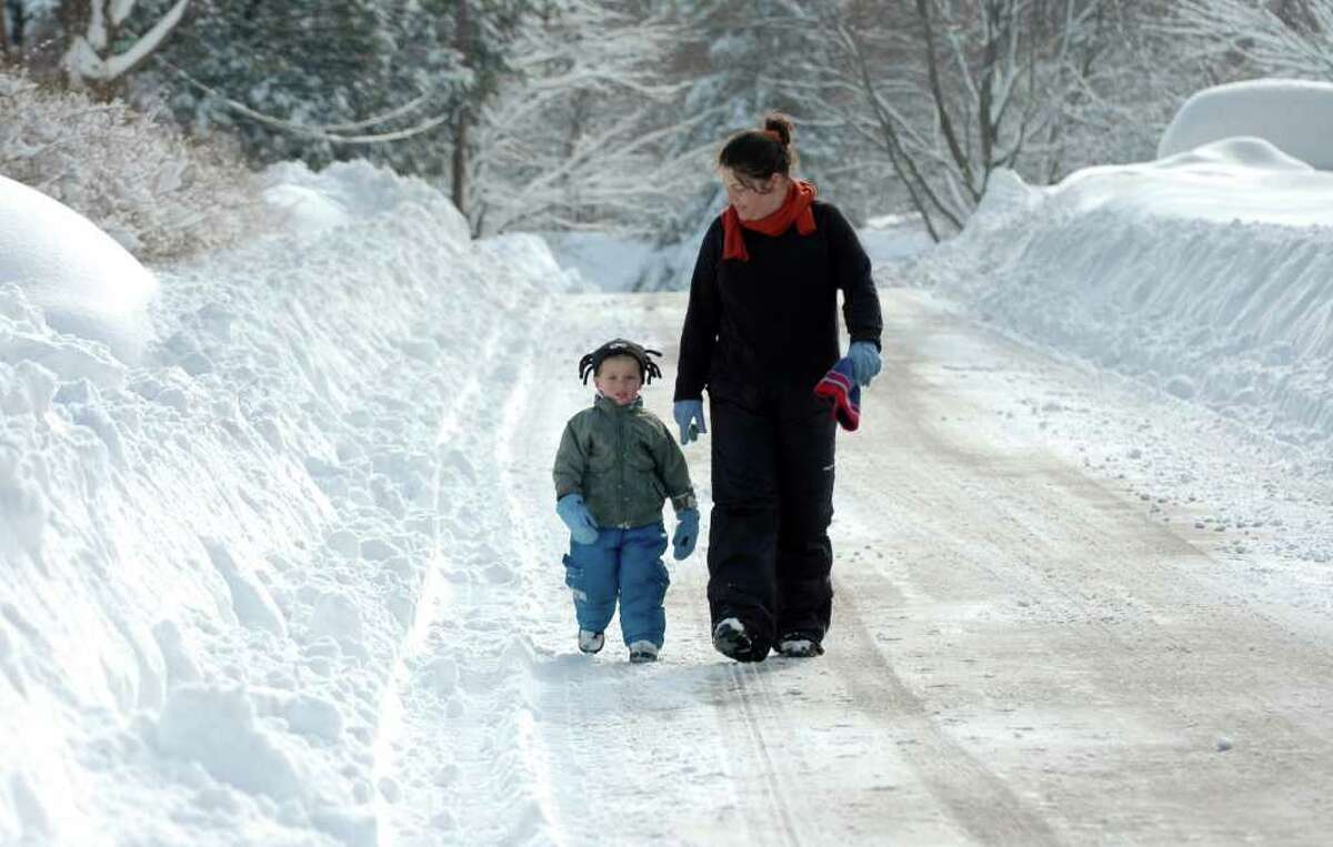2 year-old Sean Murnin and his mom, Jessa, take a walk down a snow covered Brithwell St. in Fairfield, Conn. on Thursday, Jan. 27, 2011.