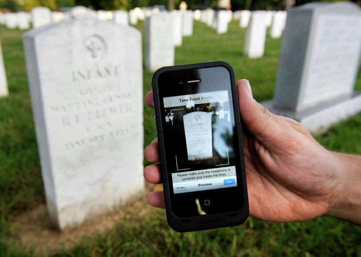 Soldiers of the Army Old Guard Task Force Christman use Apple iPhone's to photograph and catalog more than 219,00 grave markers and the front of more than 43,000 sets of cremated remains at Arlington National Cemetery in Arlington, Va., Wednesday, Aug. 24, 2011. Night after night this summer, troops have left their immaculately pressed dress blues, white gloves and shiny black boots, photographing each and every grave with an iPhone. (AP Photo/Cliff Owen)