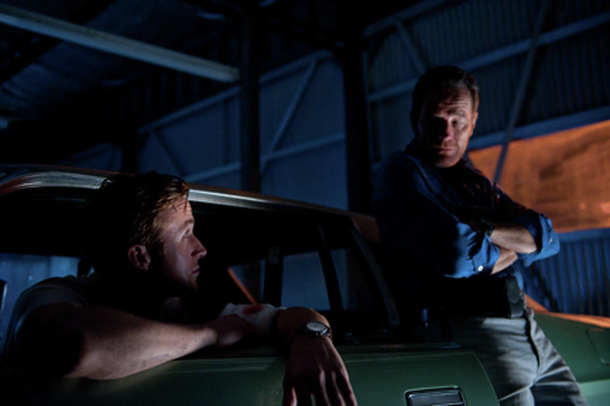 (L-R) Ryan Gosling as Driver and Bryan Cranston as Shannon in "Drive."