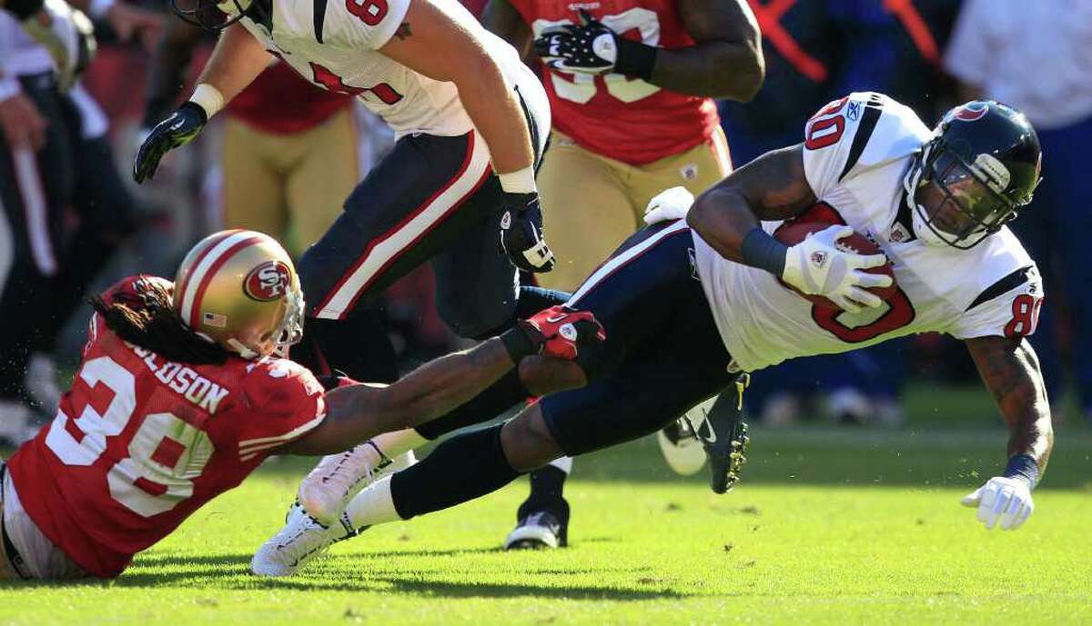 Houston Texans wide receiver Andre Johnson (80) falls forward as he is tackled by San Francisco 49ers safety Dashon Goldson (38) in the first quarter of a preseason NFL football game in San Francisco, Saturday, Aug. 27, 2011. (AP Photo/Marcio Jose Sanchez)