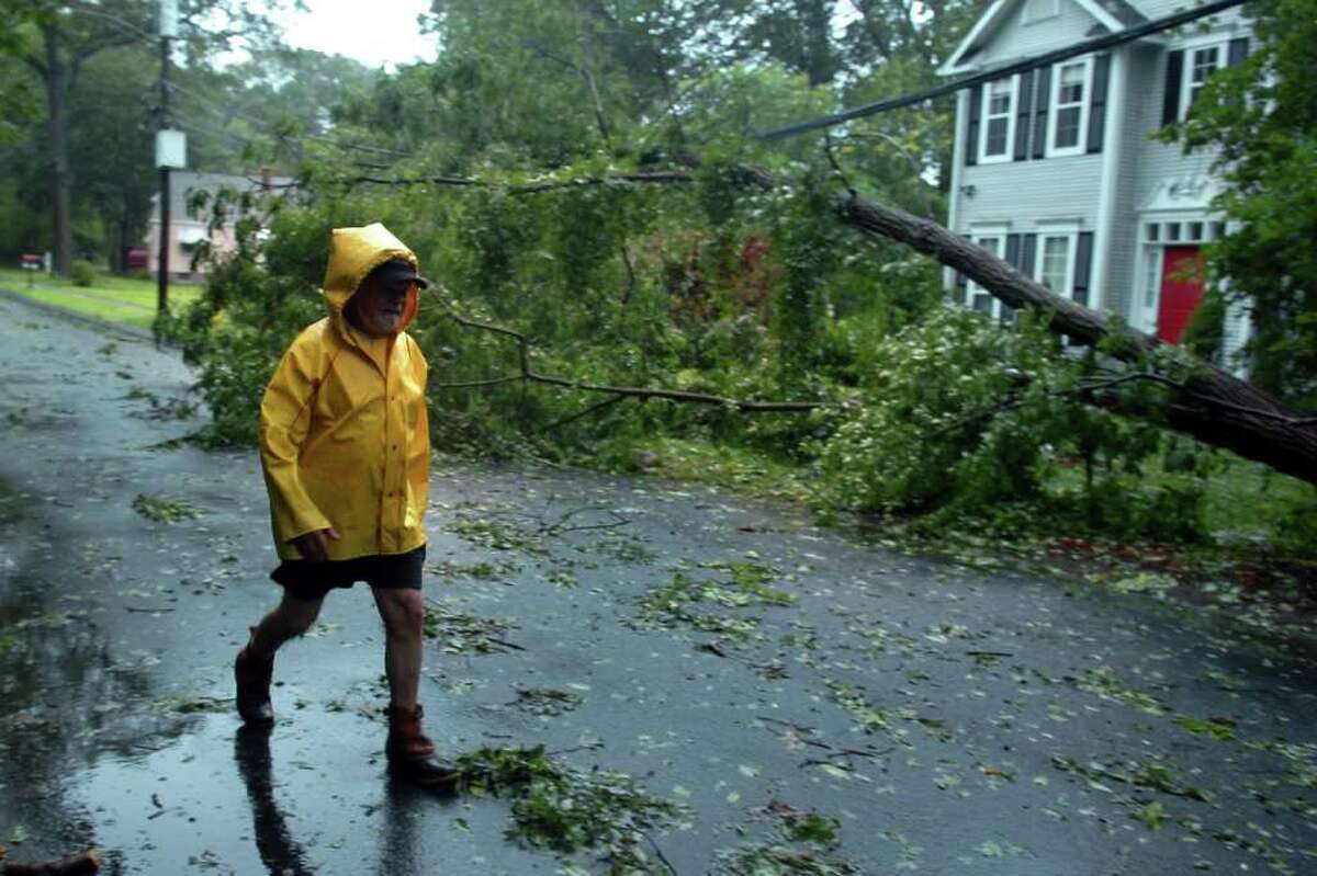 Rick Capozzi walks near downed trees and power line on Pumpkinground Rd. in Stratford, Conn. Aug. 28th, 2011.