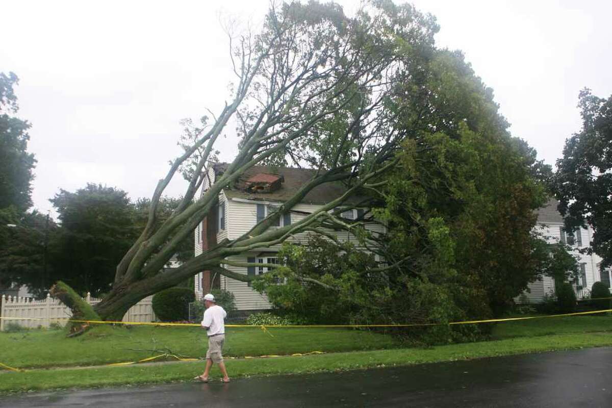 A tree hits a home on the corner of Midland St. and Lake Ave. during hurricane Irene in Black Rock in Bridgeport on Sunday August 28, 2011.