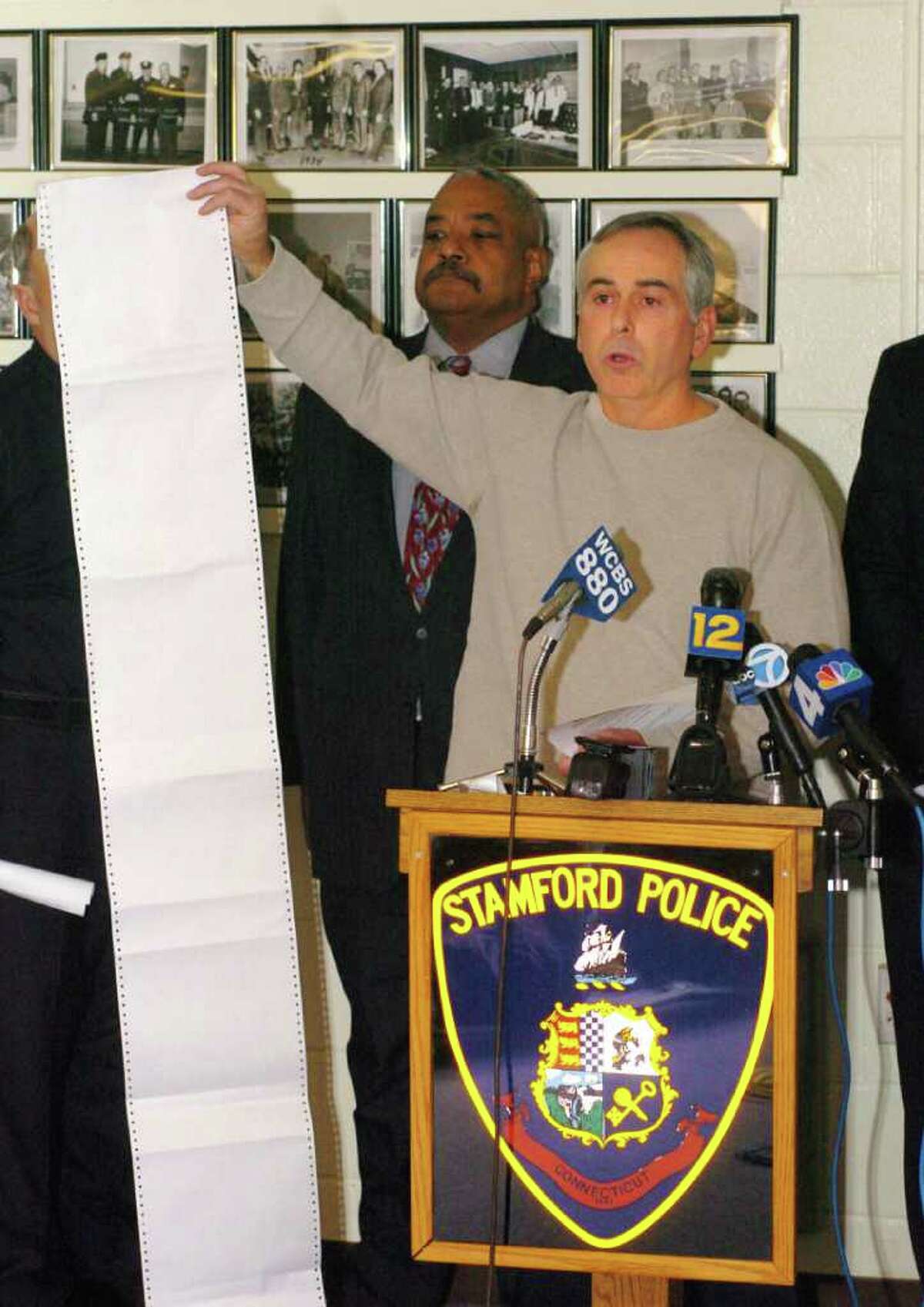 File photo 2005: Stamford Police Department announces the arrest of Harry Gonzalez and Jennifer Kos, two suspects in the murder of Joanne Trautwein. Captain Richard Conklin holds up the 'rap' sheet of Harry Gonzalez.