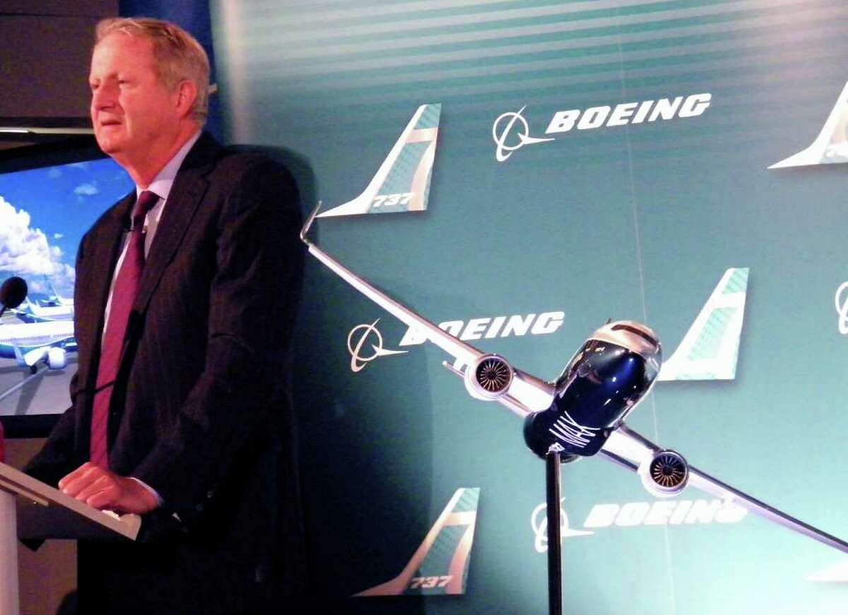 Boeing Commercial Airplanes President and CEO Jim Albaugh speaks beside a model of the new Boeing 737 MAX 8 during the company's announcement of the re-engining program on Tuesday, Aug. 30, 2011 in Renton, Wash.