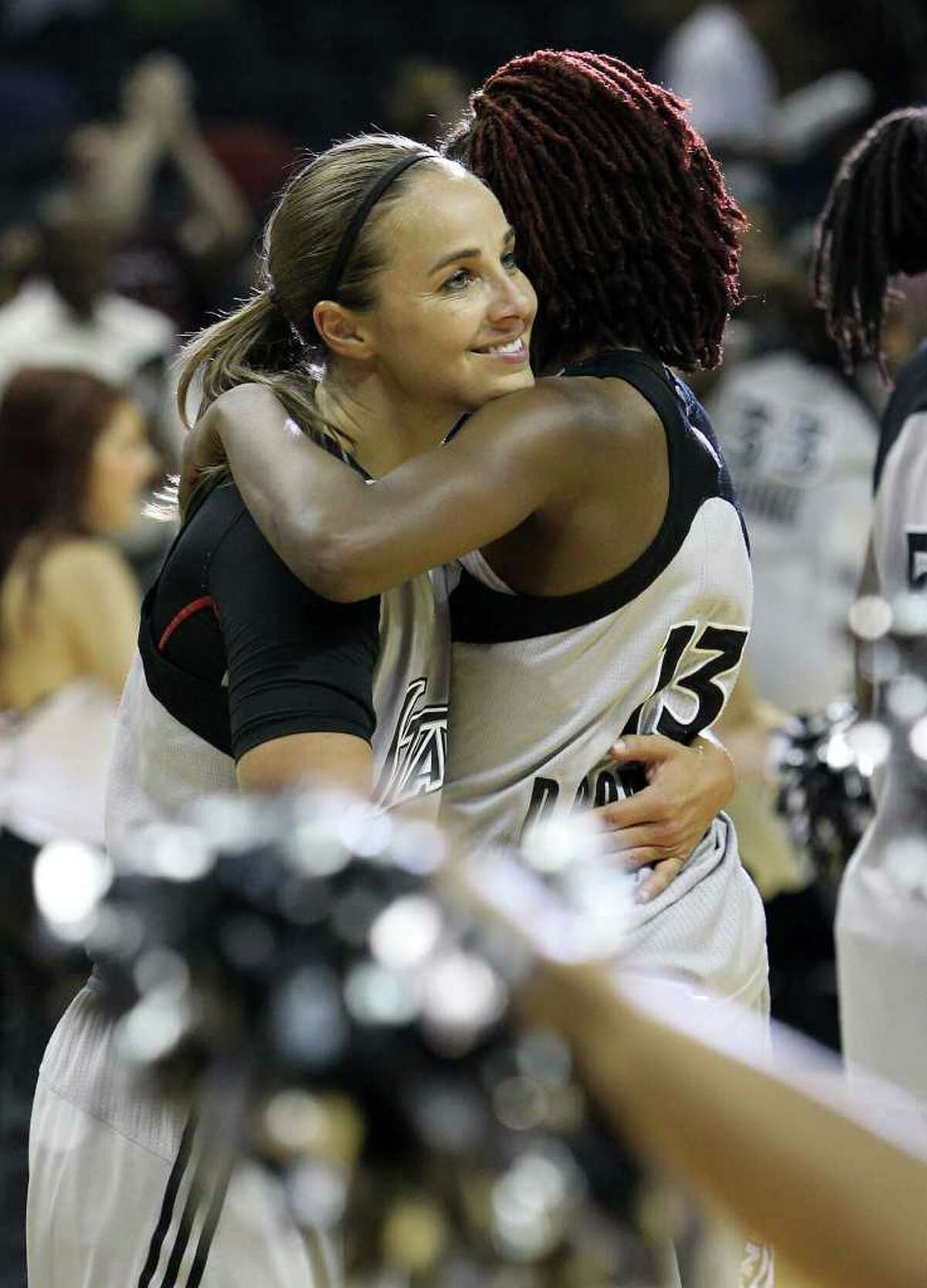 Silver Stars' Becky Hammon (25) gets a hug from teammate Danielle Robinson (13) after the Silver Stars defeated the Connecticut Sun, 78-66, at the AT&T Center on Tuesday, August 30, 2011. Hammon scored 16 points to surpass the 5,000 career point mark. Kin Man Hui/kmhui@express-news.net