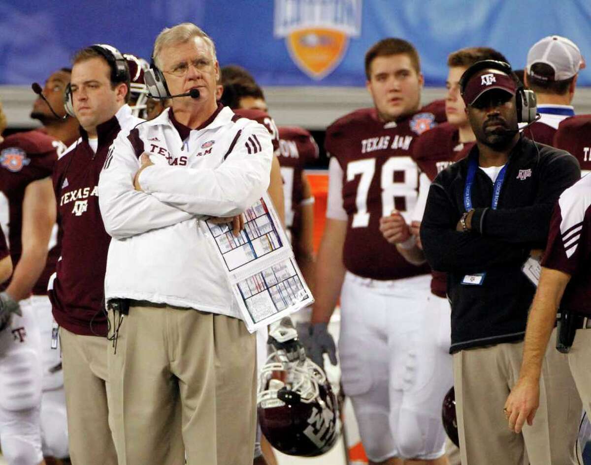 In this Jan. 7, 2011 photo, Texas A&M head coach Mike Sherman, left looks on from the sideline during the second half of the Cotton Bowl NCAA college football game against LSU in Arlington, Texas. The Aggies lost 41-24.