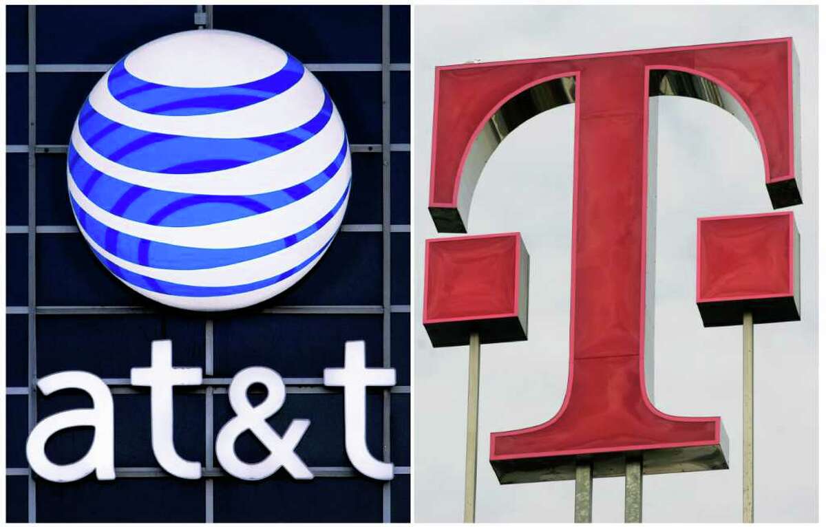 This file combination photo displays logos for AT&T, left, and Deutsche Telekom AG. The Justice Department filed suit Aug. 31, 2011, to block AT&T's $39 billion deal to buy T-Mobile USA on grounds that it would raise prices for consumers.