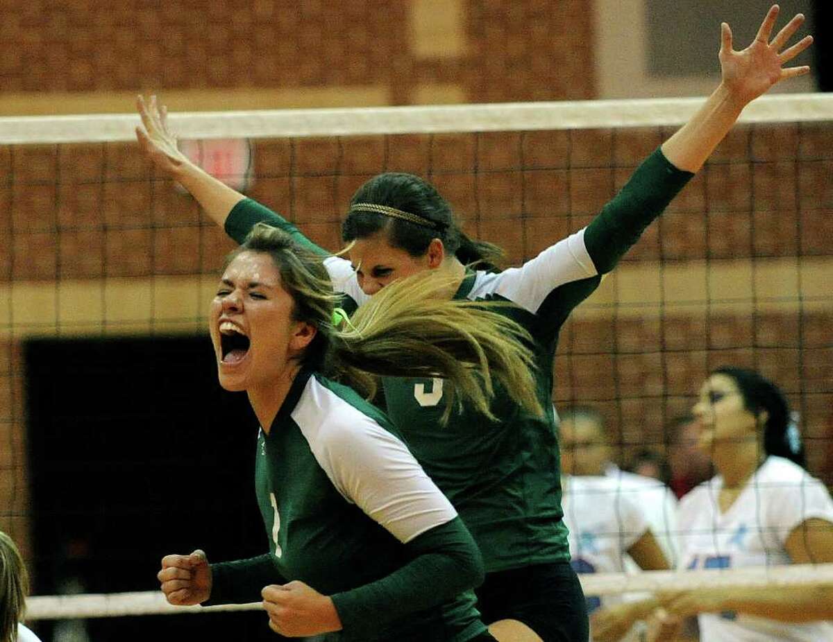 Kimberley Vaio and Kailey Manka of Incarnate Word High School celebrate after scoring a point against Antonian during girls prep volleyball action on Wednesday, Aug. 31, 2011. BILLY CALZADA / gcalzada@express-news.net