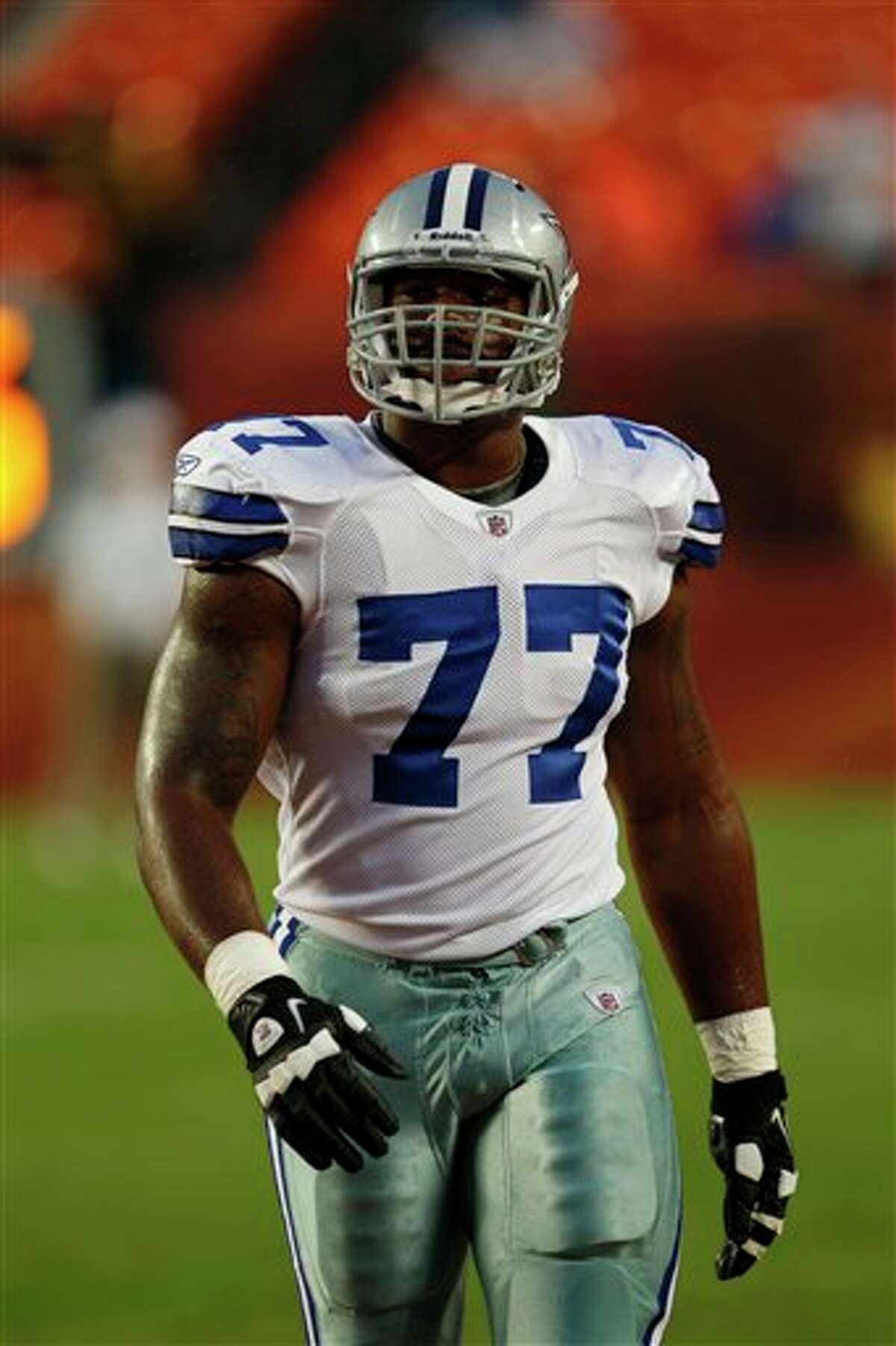 Dallas Cowboys tackle Tyron Smith (77) warms up before the start of an NFL pre season football game against the Miami Dolphins, Thursday, Sept. 1, 2011, in Miami. (AP Photo/Wilfredo Lee)