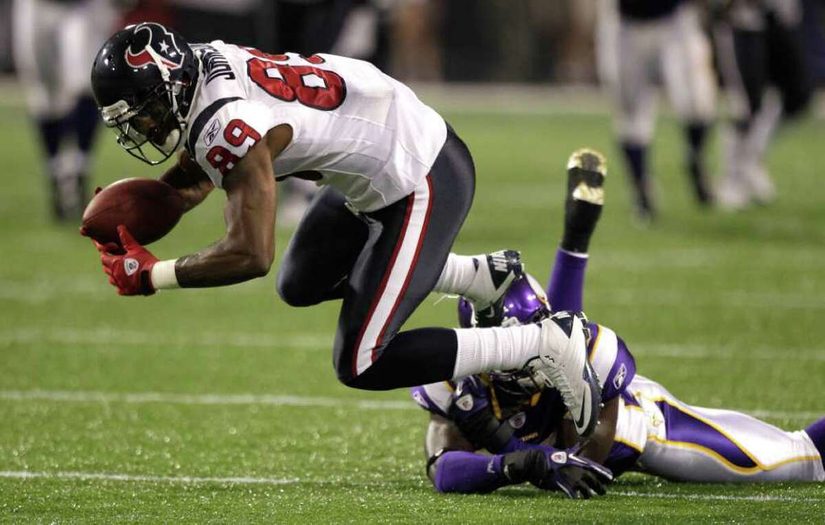 Houston Texans wide receiver Bryant Johnson (89) is tripped up by Minnesota Vikings defensive back Ryan Hill (43) during the third quarter of an NFL preseason football game at the Hubert H. Humphrey Metrodome Thursday, Sept. 1, 2011, Minneapolis. ( Brett Coomer / Houston Chronicle )