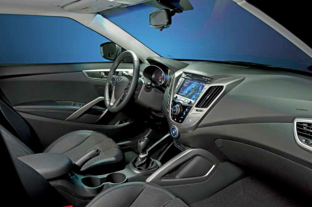 There are sporty bucket seats and metallic trim in the cockpit of the Veloster, along with a standard 7-inch touch-screen color display in the dash. COURTESY OF HYUNDAI MOTOR AMERICA