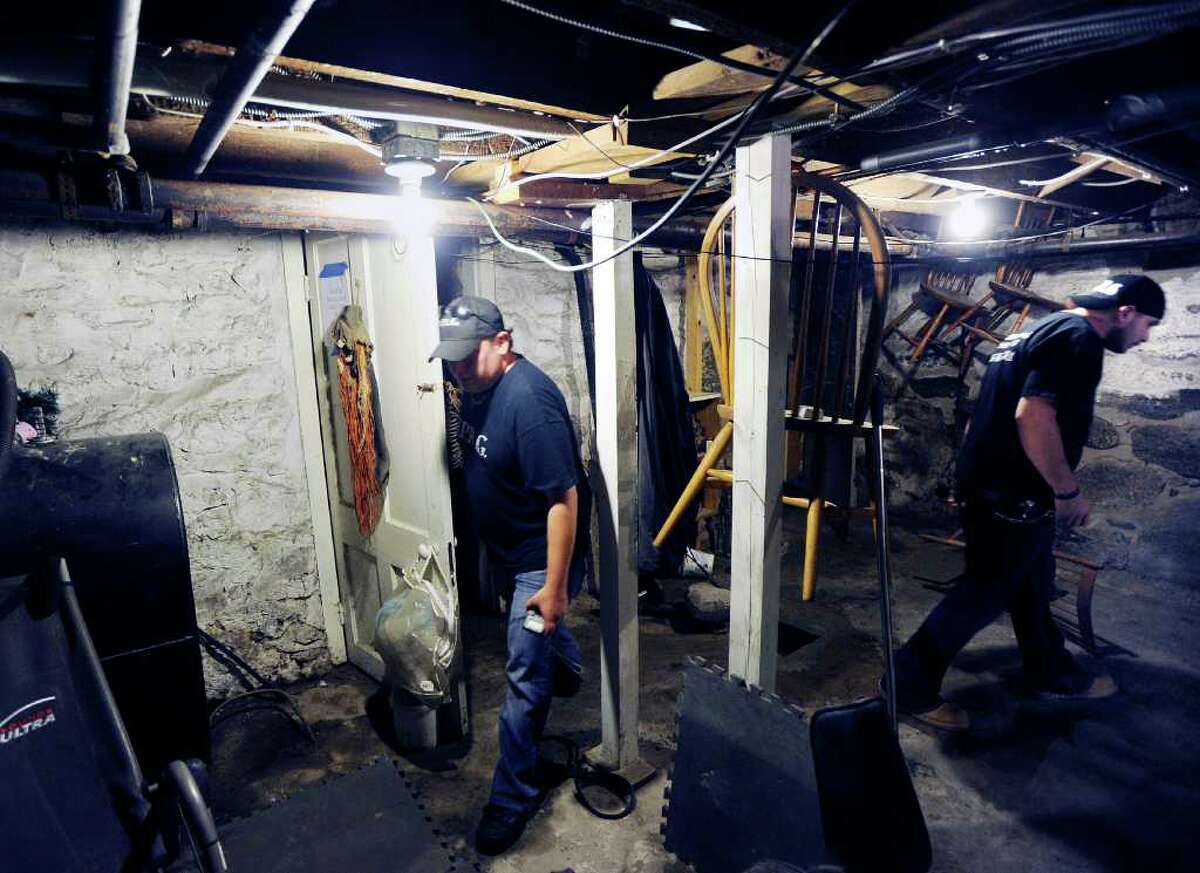 Todd Harrington, left, and Dave Rudolf, right, both of the Norwalk Paranormal Research Group, search for spirits in the basement of the Stamford home owned Melissa Leigh, Friday night, Sept. 2, 2011. Leigh said she feels the presence of her deceased father, Frederick Leigh, in the house that was owned at one time by Vivian Vance who was best known for her role as Ethel Mertz on the television sitcom "I Love Lucy."