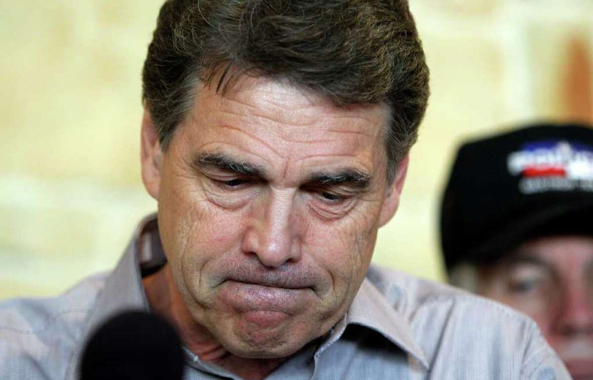 Gov. Rick Perry holds a news conference to discuss wild fires in central Texas, Monday, Sept. 5, 2011, in Bastrop, Texas. A roaring wildfire raced unchecked Monday through rain-starved farm and ranchland in Texas, destroying nearly 500 homes during a rapid advance fanned in part by howling winds from the remnants of Tropical Storm Lee. (AP Photo/Eric Gay)