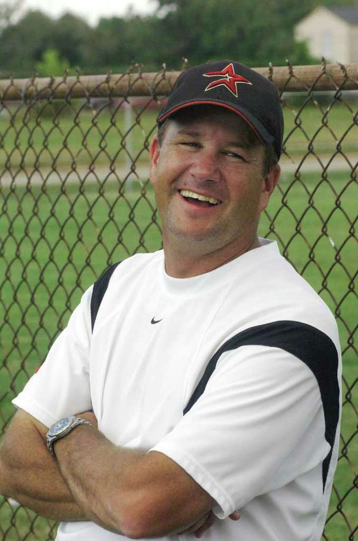 Memorial High School tennis coach, Budd Booth watches matches against Northbrook High School, Friday, Sept. 24, 2004