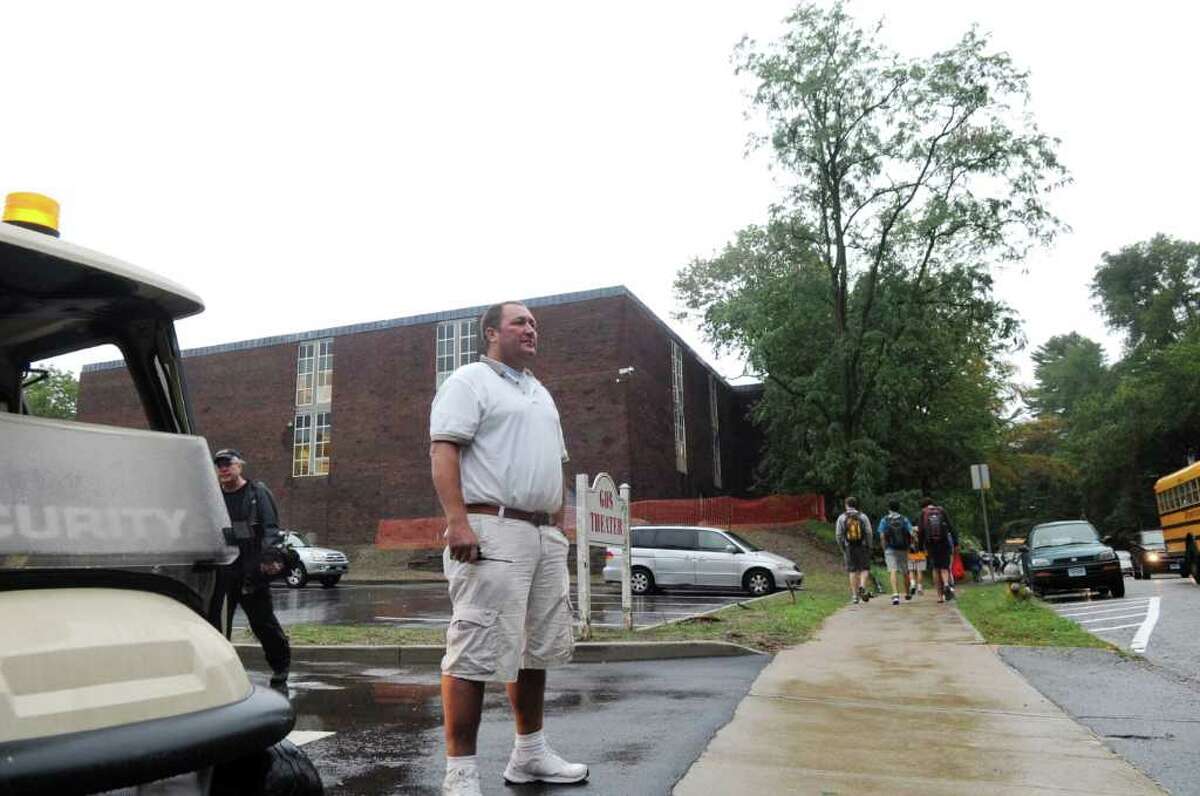 Security guard Chris Kralik directs the traffic at Greenwich High School on the first day of school, on Wednesday, Sept. 7, 2011, after pushing back the opening due to the aftermath of Hurricane Irene.