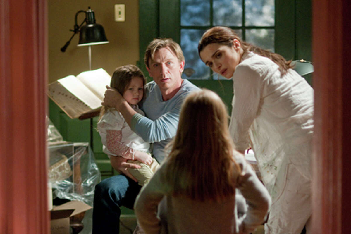 (L-R) Claire Geare as Dee Dee, Daniel Craig as Will Atenton and Rachel Weisz as Libby Atenton in "Dream House."