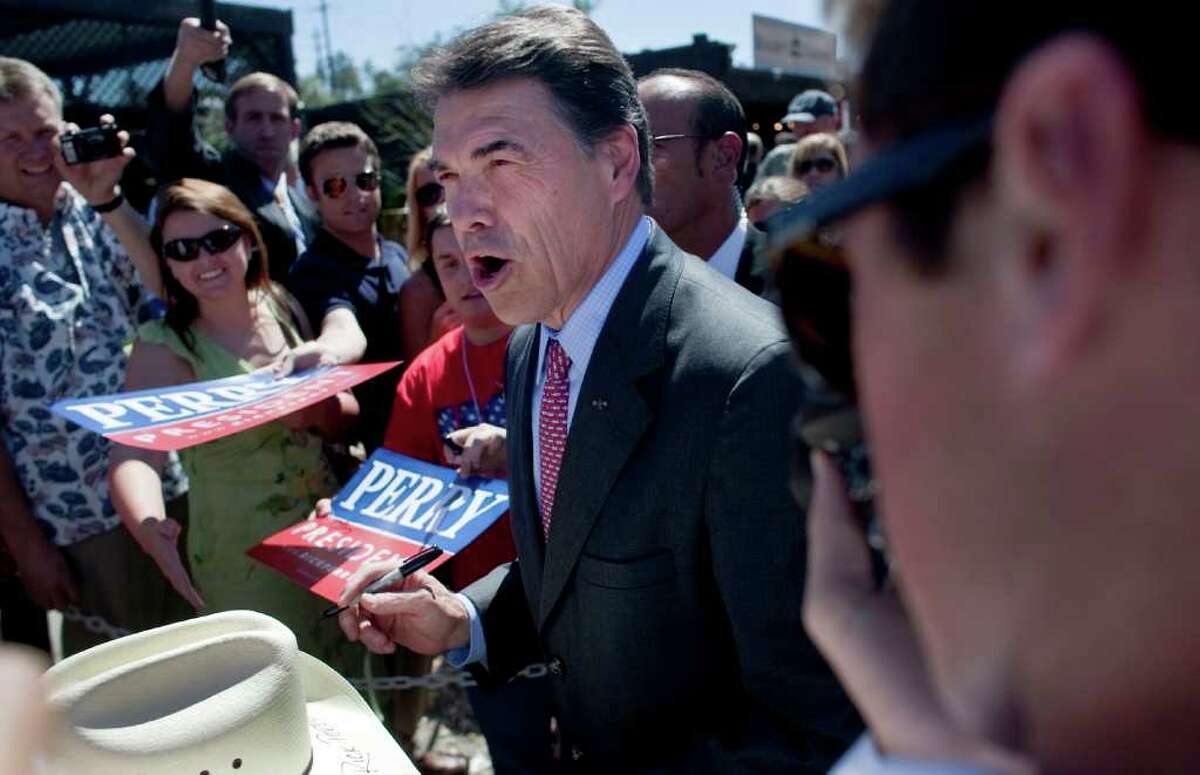 Texas Gov. Rick Perry, a candidate for the Republican presidential nomination, greets supproters during a rally at Rogers Gardens in Corona del Mar, California on Thursday, September 8, 2011. (Gina Ferazzi/Los Angeles Times/MCT)