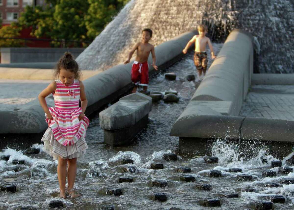 Left to right; Tuuli Walton, Isaac Lewis, and Slade Forsythe play in the fountain at Cal Anderson Park in Seattle on Saturday, Sept. 10, 2011.