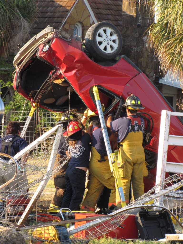 Woman hospitalized after crash leaves her pinned in car