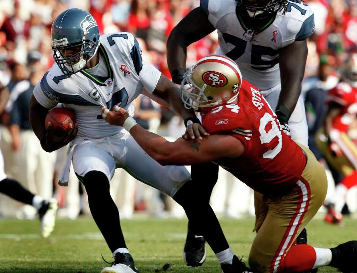 Justin Smith takes down Seahawk quarterback Tarvaris Jackson in the first half. The San Francisco 49ers defeat the Seattle Seahawks 33-17 at Candlestick Park Sunday September 11, 2011.