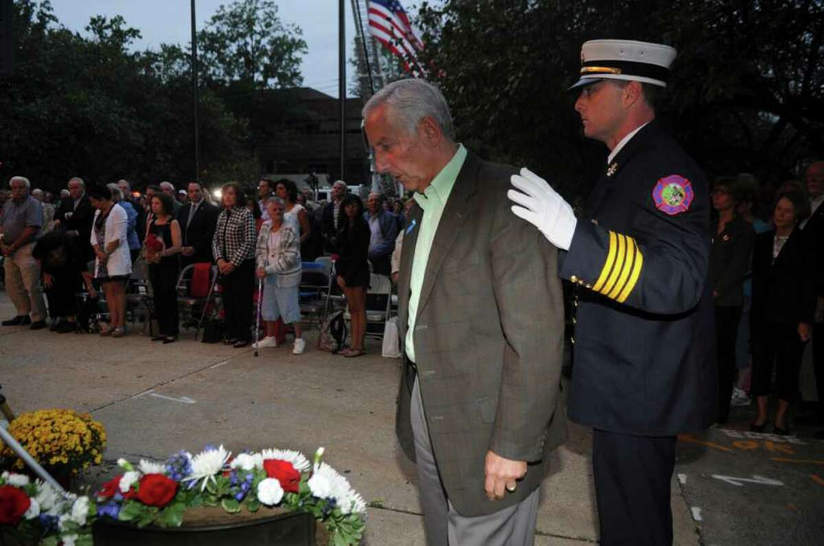 Ralph Sabbag, left, whose son Jason was killed in the twin towers in 9/11, prepares to place a wreath with help Fire Chief Robert Kick at Greenwich's September 11th to honor the memory of those lost on 9/11, especially the 23 residents who died, in a ceremony in front of the Greenwich Town Hall on Sept. 11, 2011.