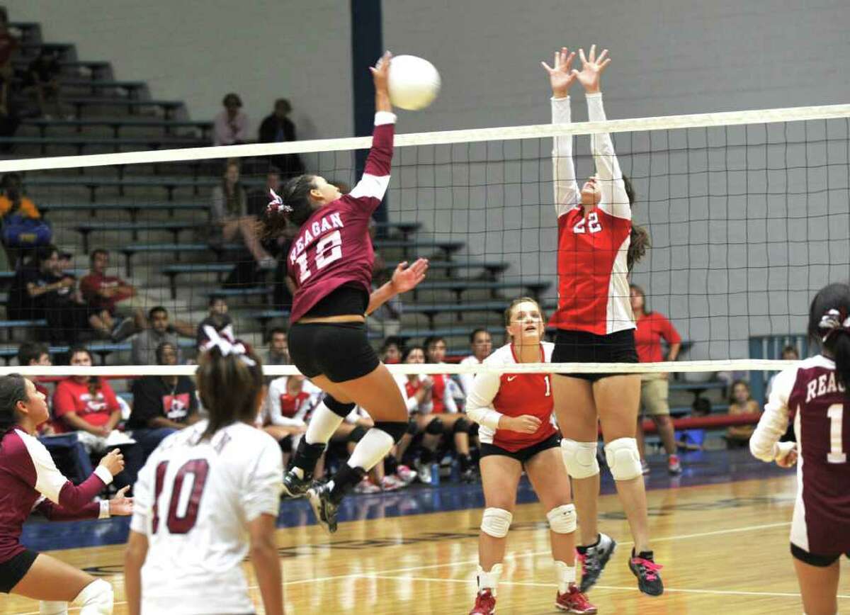 Reagan and Waltrip High Schools played a volleyball match at Delmar Field house, 9-09-11. reagan's #12 Naomi Huerta tried to hit over the outstretched arms of Waltrip's 22 Nathaly Merlos. Eddy Matchette