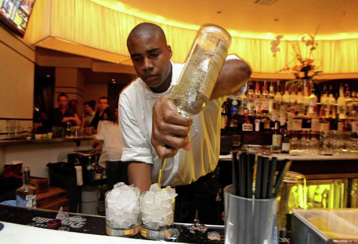 9/10/11 : Bartender David Chisolm pours two Titos Vodka drinks at the Saint Genevieve located at 2800 Kirby Suite 204 , in Houston, Texas. For the Chronicle: Thomas B. Shea