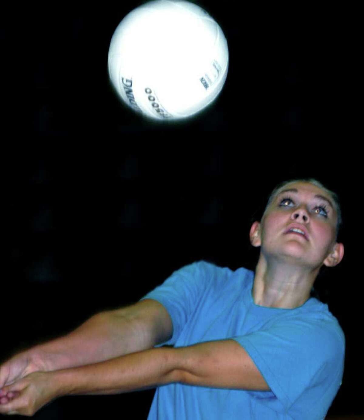 SPECTRUM/Kylie Costello of New Milford High School volleyball works on her passing skills during pre-season practice. September 2011
