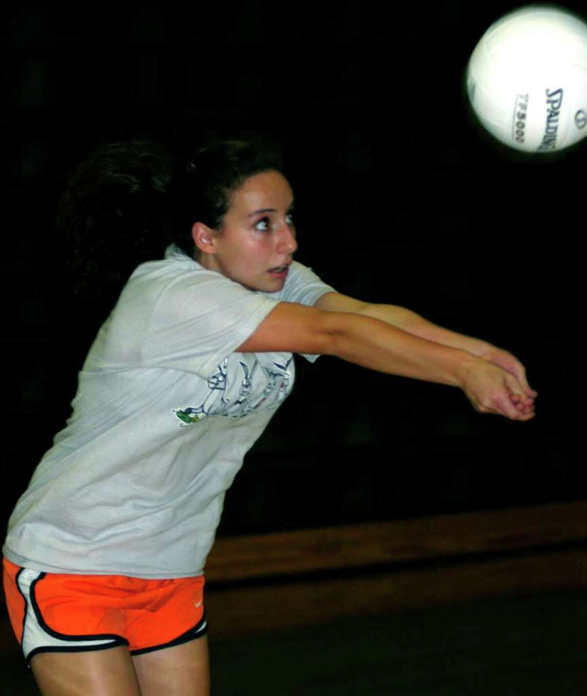 SPECTRUM/Julianna Fusco of New Milford High School volleyball works on her passing skills during pre-season practice. September 2011