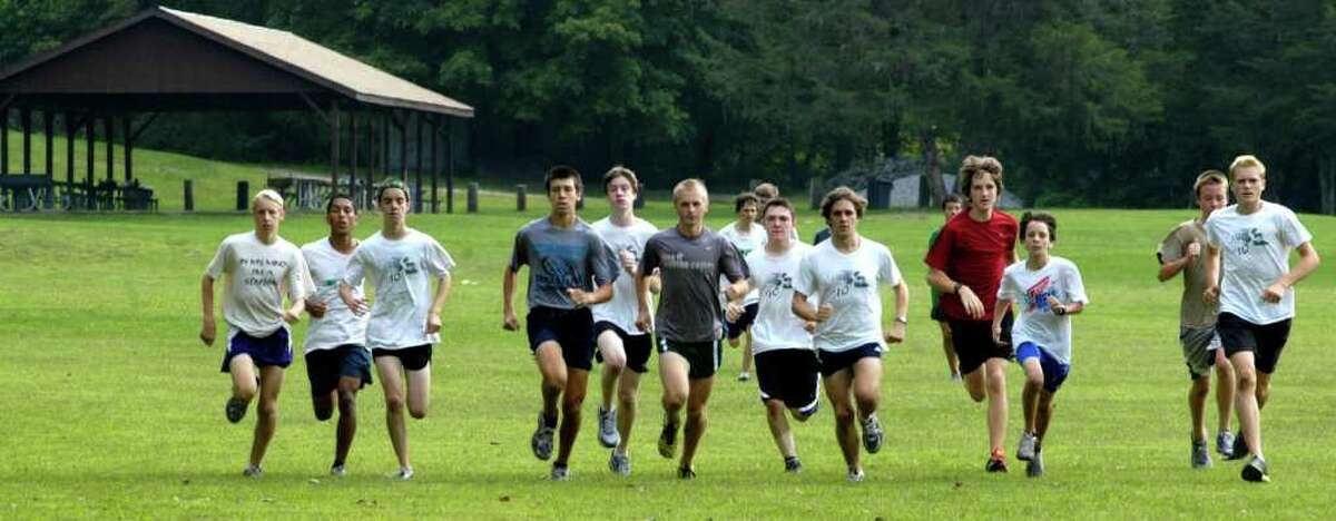 SPECTRUM/Rivals in the South-West Conference know the New Milford High School boys' cross country team will be coming right at them this fall in quest of the Green Wave's 10th straight league championship. Above, the NMHS harriers prep for the fall campaignj with a workout at Clatter Valley Park. September 2011