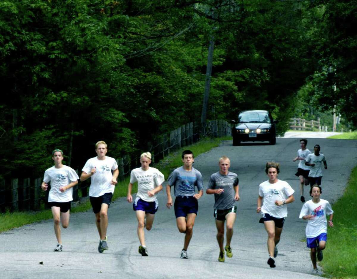 SPECTRUM/The lead pack of Green Wave runners stretches it out along North Lillinonah Road during pre-season practice for New Milford High School boys' cross country. Showing the way are, from left to right, Adam Dengler, Zach Guptill, John Hansell, Ryan Clarke, Noah Rossiter, Stephen Anderson and Greg Hansell. September 2011