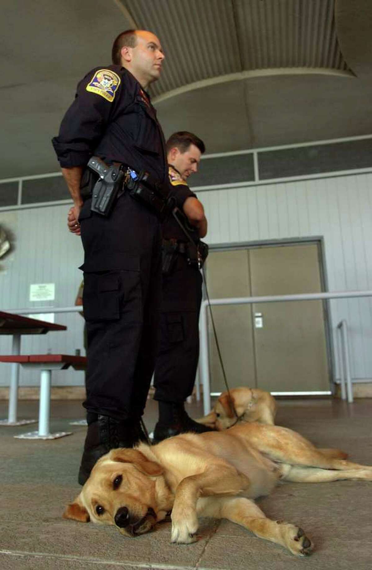 Connecticut State Police K9 Officer Mark Packer stands with his dog Regis, during a Ceremony Honoring Connecticut's 9/11 First Responders and Volunteers at Sherwood Island State Park in Westport, Conn. on Tuesday September 14, 2011.