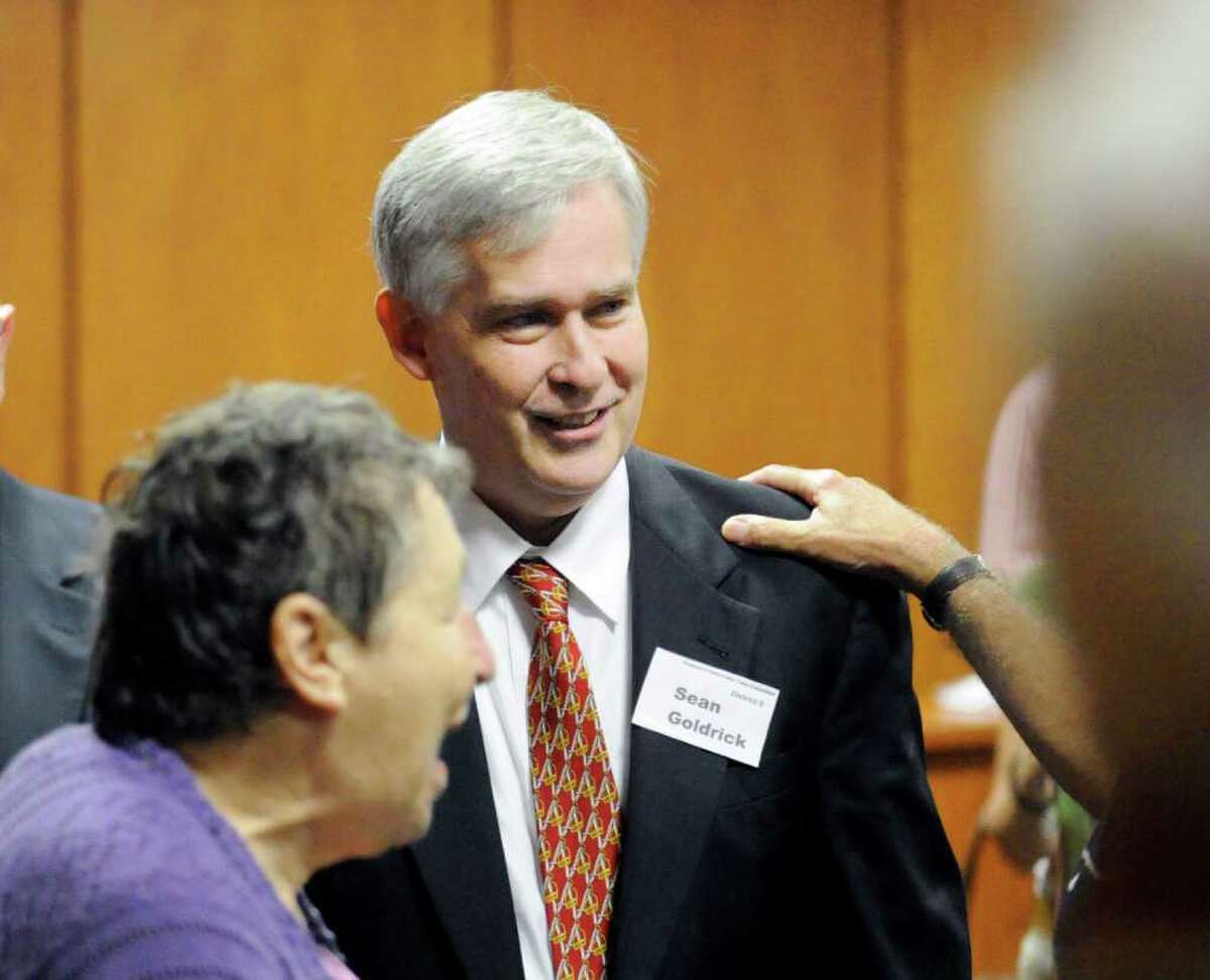 Sean Goldrick, center, smiles after winning the nomination to fill ex-Board of Estimate and Taxation member Nancy Barton's spot on the ballot for the November election during a Democratic Town Committee nomination meeting at Greenwich Town Hall Wednesday night, Sept. 14, 2011.