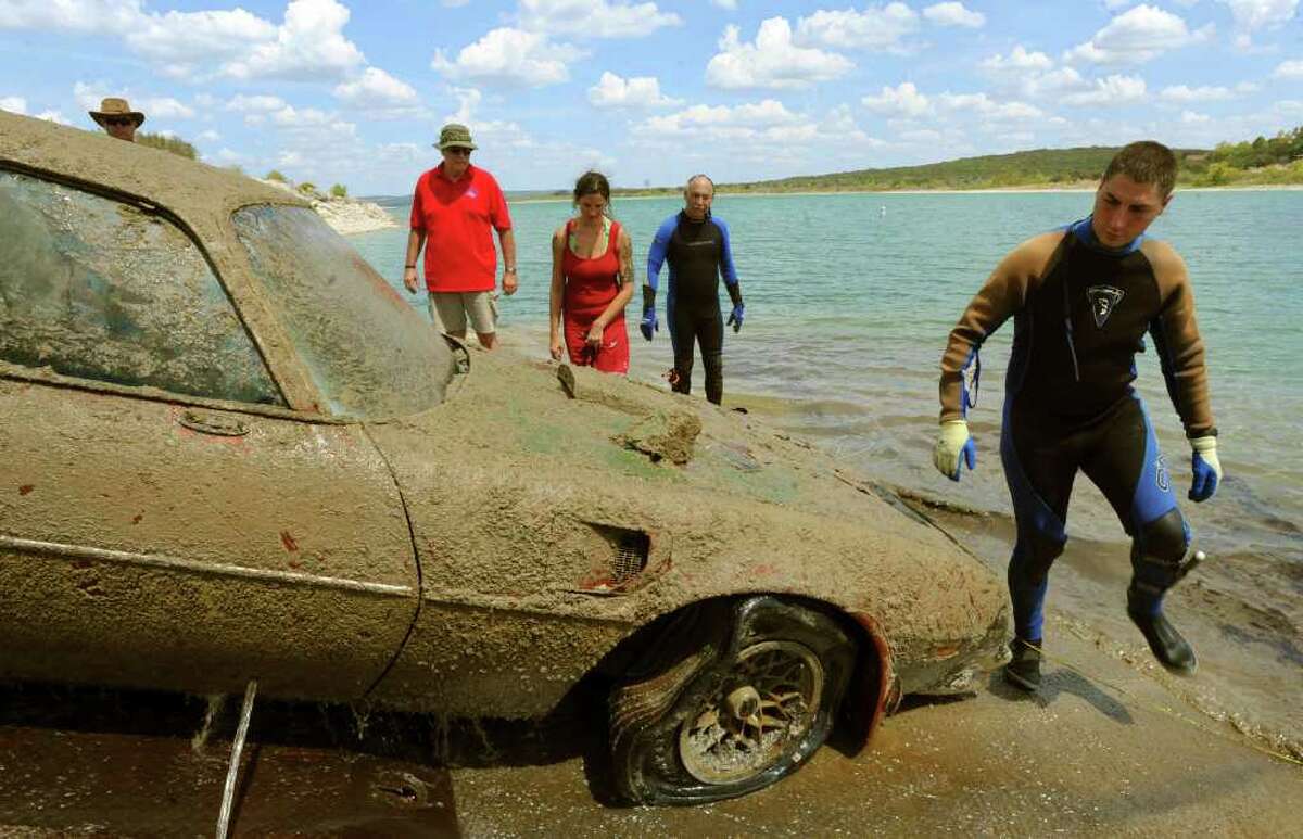 Matt Simkin (right) and other members of the San Marcos Area Recovery Team examine a car that they recovered during a training exercise at Canyon Lake. The team was formed more than 20 years ago to help small law enforcement agencies with underwater searches.