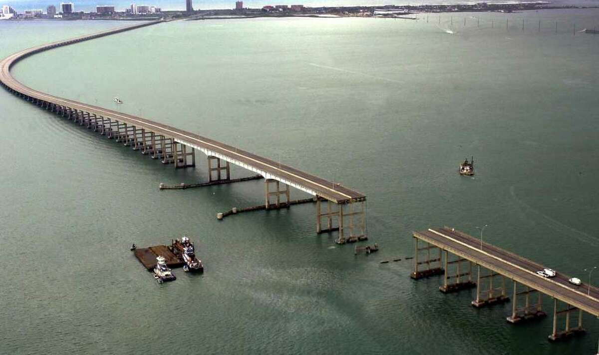 A section of the Queen Isabella Causeway is shown missing as crews survey break from their search and rescue due to an approaching storm in Port Isabell, Texas, Saturday, Sept. 15, 2001. An 80 section of the bridge collapsed when it was struck by a barge early Saturday morning. At least two people were killed and servral others are missing as cars plunged into the water.