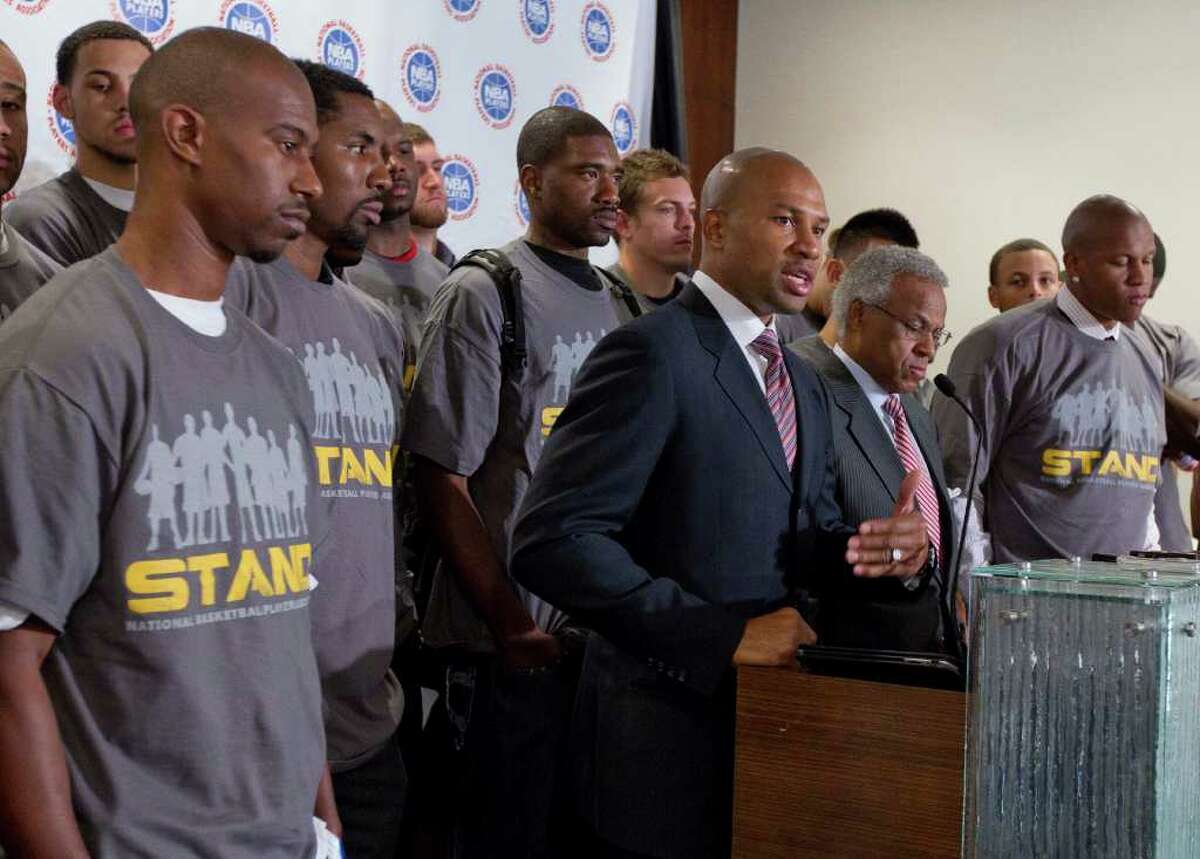 JULIE JACOBSON: ASSOCIATED PRESS FISH AND FRIENDS: With about 35 players association reps, Lakers point guard and union president Derek Fisher, center, speaks during Thursday's news conference.