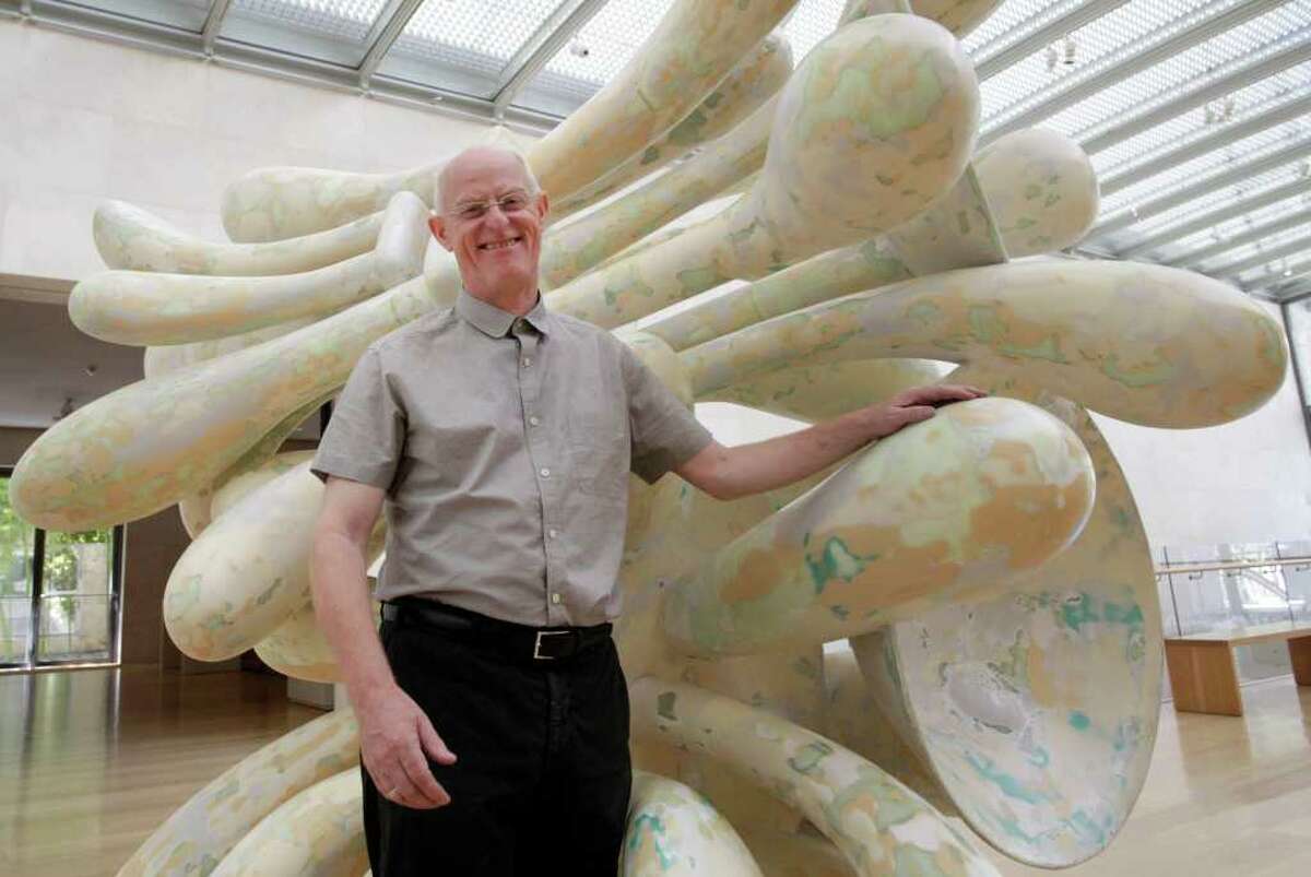 Artist Tony Cragg stands by one of his pieces of art titled "Companions" at the Nasher Sculpture Center, Thursday, Sept. 8, 2011, in Dallas. An exhibit of works by the British sculptor Cragg is set to open in Dallas, his first U.S. museum exhibition in nearly 20 years. The exhibit opening Saturday will feature about 30 works, most from the last 10 years. (AP Photo/Tony Gutierrez)