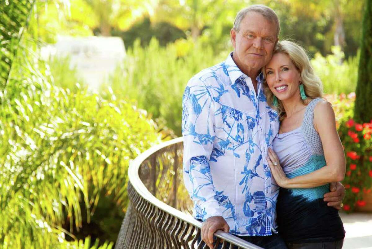 Matt Sayles : ASSOCIATED PRESS last hurrah: Musician Glen Campbell, left, and his wife, Kim, pose in Malibu, Calif., this summer. Campbell, who has Alzheimer's disease, is on a farewell tour before retiring. He recently released what he says will be his final album.