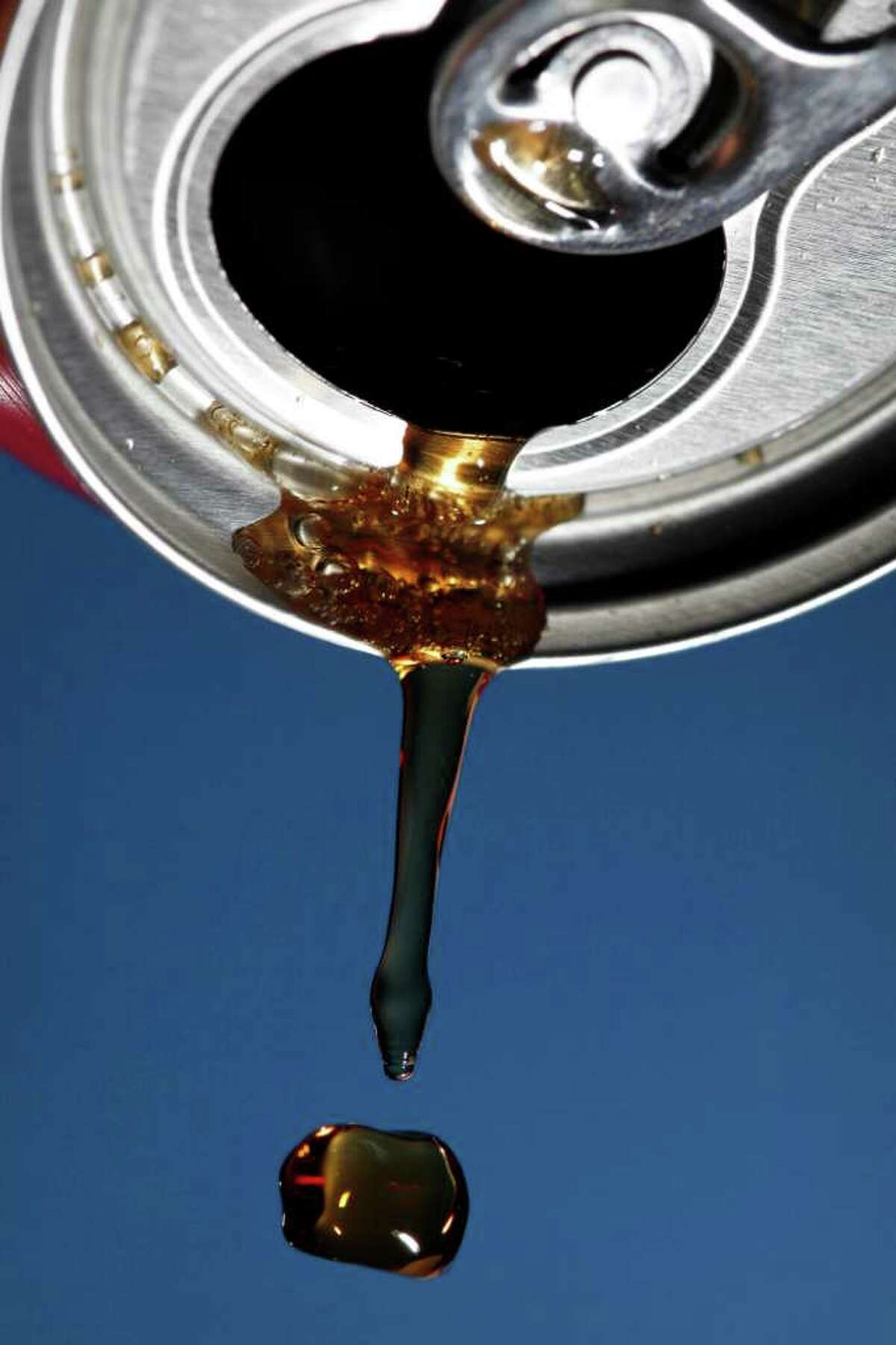 This photo illustration shows soda being poured from a can Thursday, Sept. 15, 2011, in Philadelphia. A recent attempt by the corn industry to change the name of a widely used but increasingly controversial sweetener was misleading and could have robbed consumers of important information, a top official at the Food and Drug Administration said in documents obtained by The Associated Press.(AP Photo/Matt Rourke)