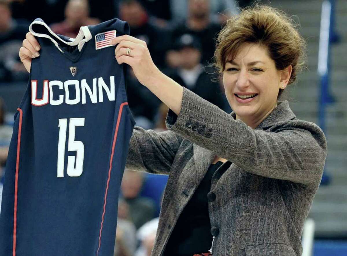 Susan Herbst, newly named 15th president of the University of Connecticut holds up a Connecticut jersey during an NCAA basketball game in Hartford, Conn., Monday, Dec. 20, 2010. Herbst told Hearst Connecticut Newspapers on Tuesday, September 20, 2011 that UConn is in a tough position regarding conference expansion because the Huskies can't control the timetable. (AP Photo/Jessica Hill)