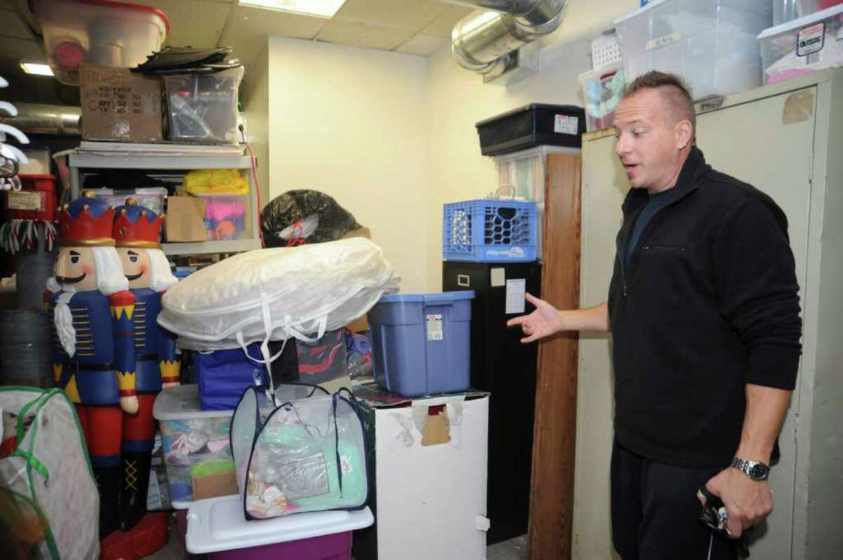 Scott Sisbarro, director of the St. Savior School of Dance, shows a storage space at St. Saviour's Episcopal Church where the school placed its supplies following flooding from Tropical Storm Irene. The school has temporarily moved to a vacant storefront at 184 Sound Beach Ave. while it repairs flood damage from the storm.