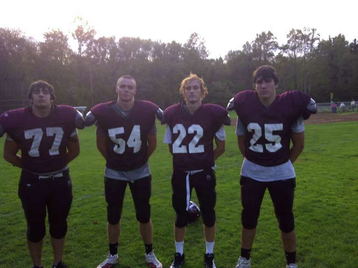 From left, St. Luke's football captains Joe Bonaddio, Sam Fuller, Greg Sellhausen and Adam Connolly pose for a picture after practice on Tuesday Sept. 20 at St. Luke's High School. St. Luke's opens its season with a home game against Hopkins at 1 p.m. Saturday.