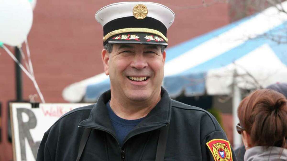 FILE - Fire Chief Lou LaVecchia prepares to walk in the 5th Annual "Walk a Mile in Her Shoes" event, sponsored by The Milford Rape Crisis Center, in Milford on Sunday, April 10, 2011.