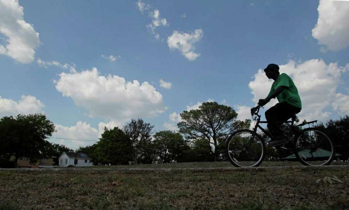 Charles Pruitt, 58, rides his bike through Emancipation Park Wednesday, Sept. 21, 2011, in Houston. Emancipation Park on the corner of Elgin and Dowling received a $1 million grant from the Texas Parks and Wildlife Commission that brings the city about three-quarters of the way to raising the $10.5 million needed for a planned redevelopment of the historic park in the Third Ward city officials said Wednesday. Plans include an "iconic" piece of sculpture and a new amphitheater for concerts. The park was founded by ex-slaves in 1872. "This park means a lot," Pruitt said who comes to the park almost daily. "It has a lot of history behind it." ( Johnny Hanson / Houston Chronicle )