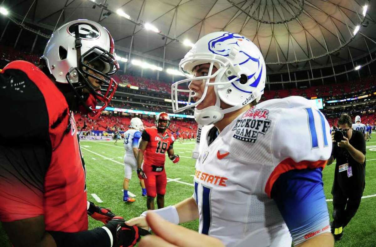 When quarterback Kellen Moore (right) and Boise State took on Georgia at the beginning of the season on Sept. 3, both teams made a splash with their eye-catching uniforms and apparel.  SCOTT CUNNINGHAM/GETTY IMAGES