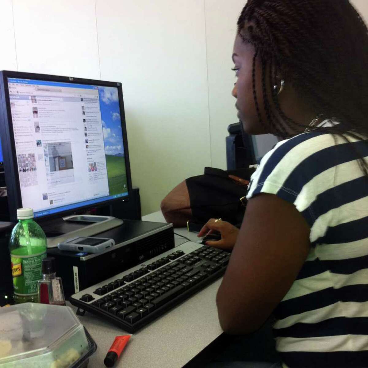 Geralda Moise, 20, a mass communications major at the University of Bridgeport, scans Facebook during her media management class at U-B. Moise is one of many Facebook users who dislike the recent crop of changes to the social media site.