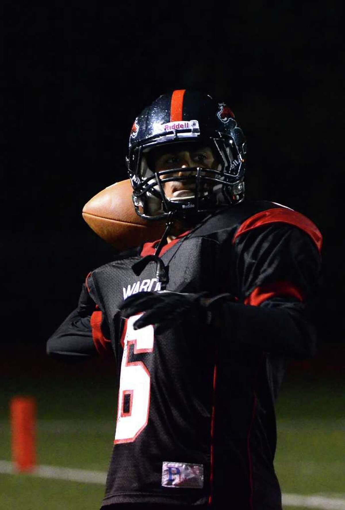 Fairfield Warde's Anthony Miller (6) warms up the quarterback during the football game against Darien at Fairfield Warde High School on Friday, Sept. 23, 2011.